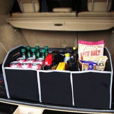 an open trunk with drinks and snacks in the back seat on a car's cargo area