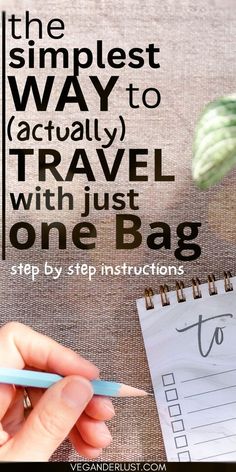 a person writing on a notepad with the words, the simpleest way to actually travel with just one bag