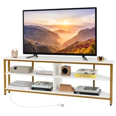 a flat screen tv sitting on top of a white shelf