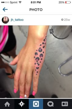 a person's hand with a tattoo on it