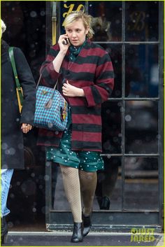 a woman walking down the street talking on her cell phone