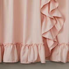 pink curtains with ruffles hanging from them