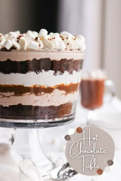 there is a chocolate cake with whipped cream on top and hot chocolate in the bottom