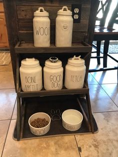 dog food and water are displayed in front of a wooden crate with words on it