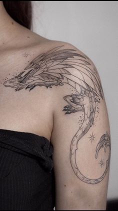 a woman with a dragon tattoo on her shoulder