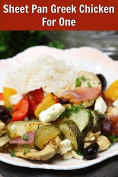 a white plate topped with meat and veggies next to rice on a table