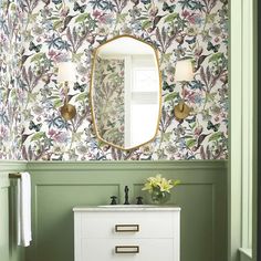 a bathroom with green walls and a mirror on the wall above it, next to a white dresser