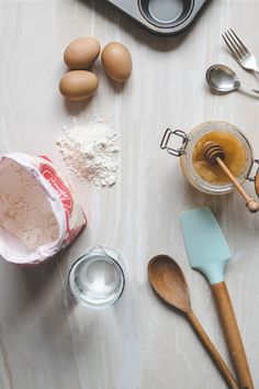 an assortment of baking ingredients and utensils on a table