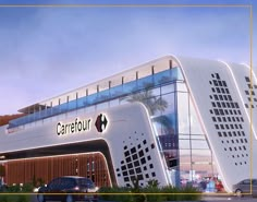 a large white building with cars parked in front of it and the words carretour above it