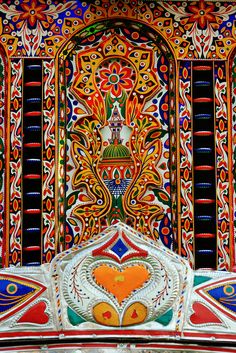 an intricately decorated wall with colorful designs