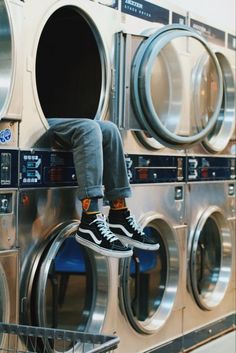 a person sitting on top of a stack of washers