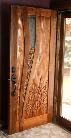 the front door is made out of wood and has an intricate carving pattern on it