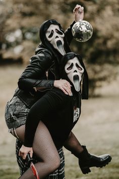 two people in masks are hugging each other