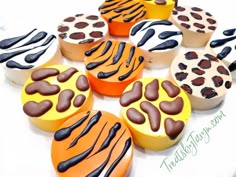 cupcakes decorated with chocolate and orange icing are arranged in the shape of zebra stripes