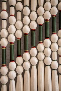 many white and green spools of thread are arranged together