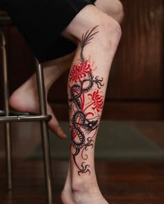 a person with a dragon tattoo on their leg