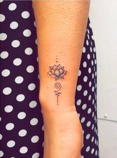 a woman's arm with a tattoo on it and a flower in the middle