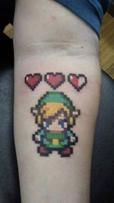 a person with a tattoo on their arm that has an image of mario and hearts