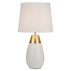 a white and gold table lamp with a white shade on the top, against a white background