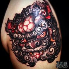 an artistic tattoo design on the back of a woman's left arm and shoulder