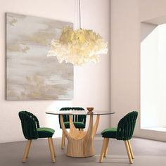 a dining room table with green chairs and a painting on the wall