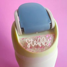 an ice cream maker with the word steffy on it's lid and sprinkles