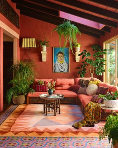 a living room filled with lots of furniture and potted plants on top of it