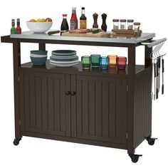 a kitchen island with plates and bowls on it next to bottles, glasses and other items