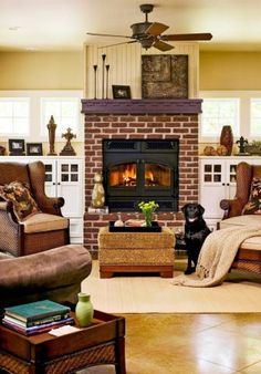 a living room filled with furniture and a fire place in the middle of the room