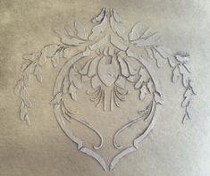 an intricately designed piece of paper with leaves on it