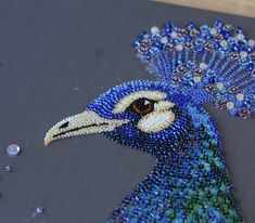 a peacock made out of beads on top of a table