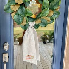 a door with a wreath on it and a bag hanging from the front door handle