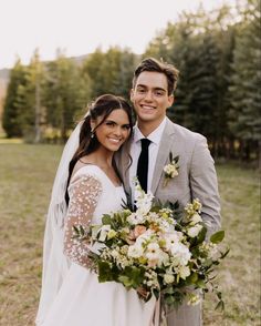 a bride and groom pose for a wedding photo