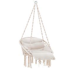 a white hanging chair that is made out of rope and has two pillows on it