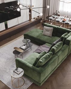 a living room filled with green couches and tables