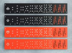 three different types of stickers on a gray surface, each with an orange and black design