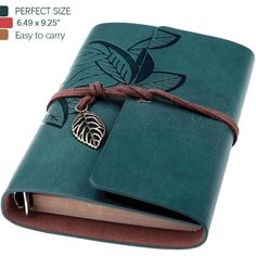 a green leather journal with a leaf charm