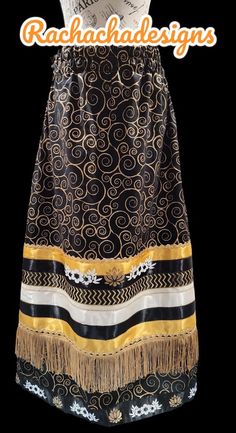 an image of a woman wearing a dress with gold and black designs on the skirt