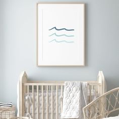 a baby's room with a white crib and blue walls