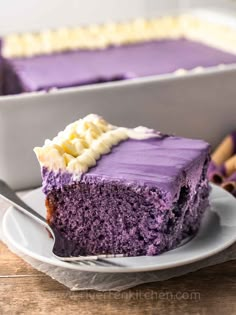 a slice of purple cake on a white plate