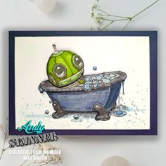 a card with an image of a green robot taking a bath in a blue tub