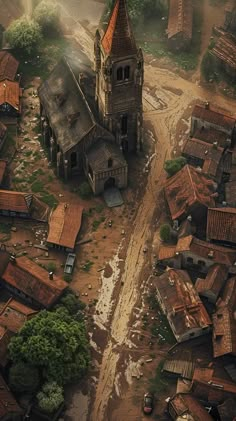 an old church surrounded by mud and trees in the middle of town, from above