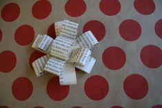 several pieces of paper that have been cut into squares on a polka dot tablecloth