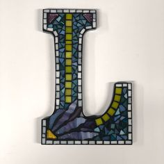 the letter l is made up of stained glass and has a mosaic pattern on it