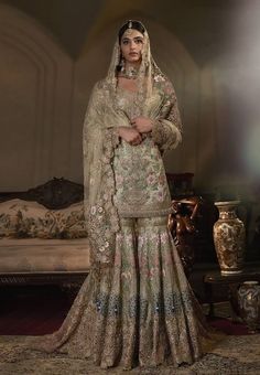 a woman in a wedding dress posing for the camera