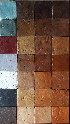 several different colors of cement sitting on top of each other in a square pattern,