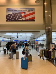 people with their luggage at an airport terminal