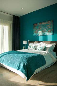 a bedroom with teal walls and wood floors