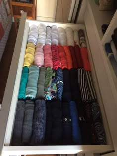 an open drawer filled with lots of colorful socks