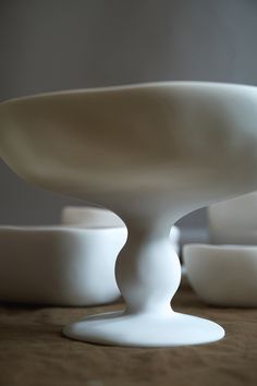 a white bowl sitting on top of a wooden table